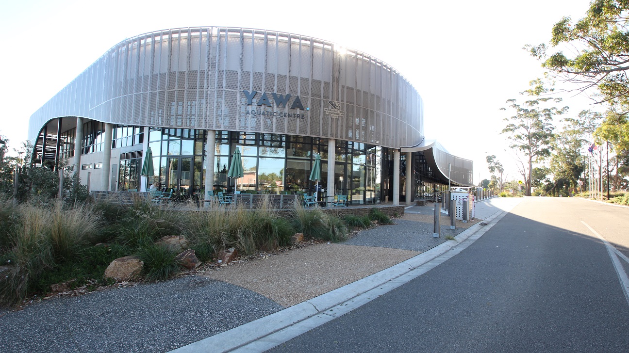 Yawa Aquatic Centre is a large modern, architecturally designed building featuring steel and glass in a soft curved wave-like pattern. The venue is located on Besgrove Street in the Rosebud sporting precinct of Olympic Park. The glass walls reflect the surrounding area creating a natural setting and environment.